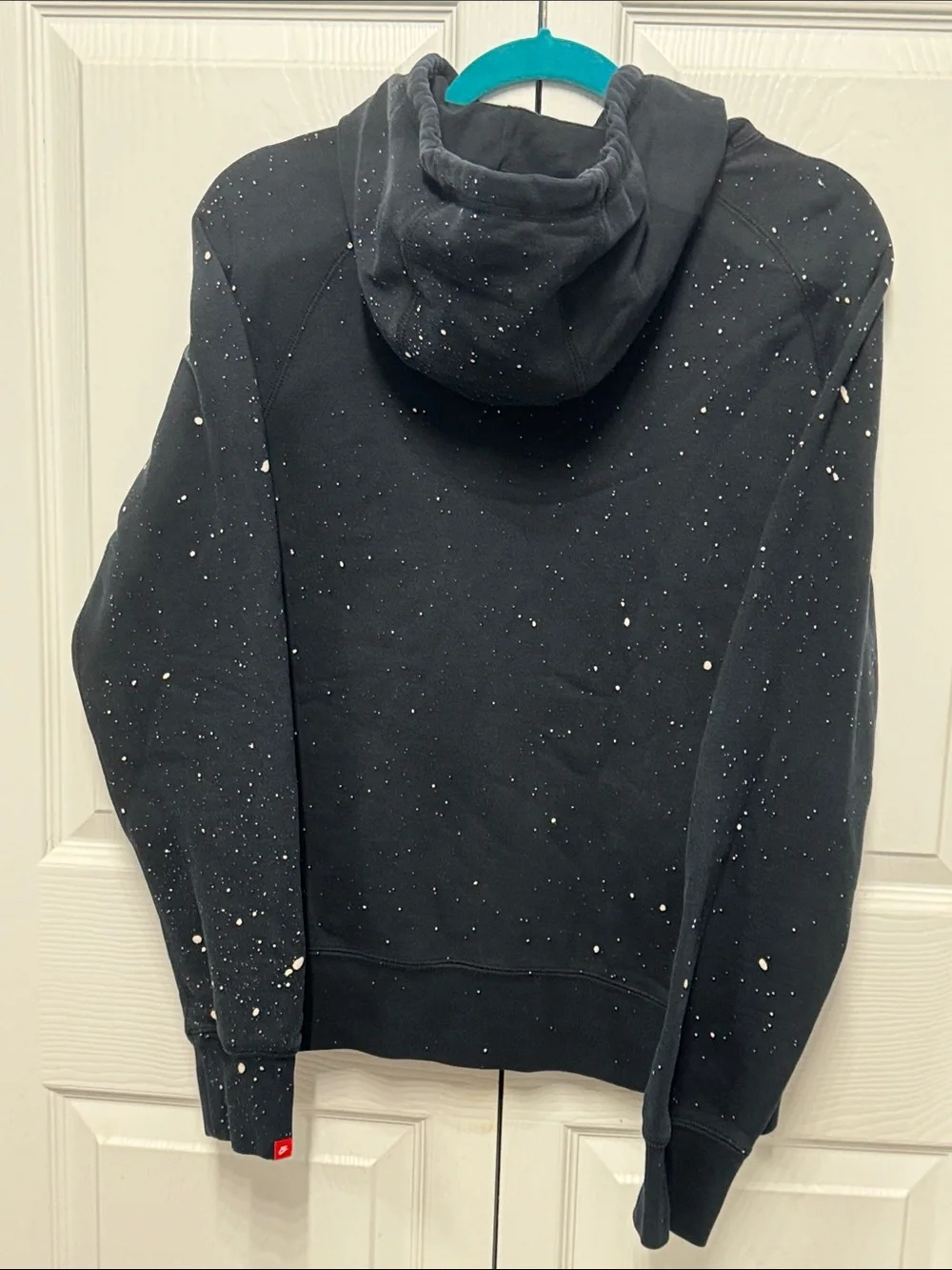 Nike Black Pullover Hoodie with White Swoosh and Paint Speckle